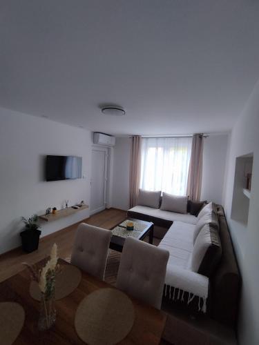a living room with a couch and a table at Apartman Limski Kutak in Železnička Stanica Prijepolje