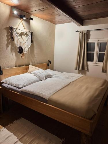 a bedroom with a large bed with a wooden frame at Ferienhaus Landliebe 1753 in Bad Gleichenberg