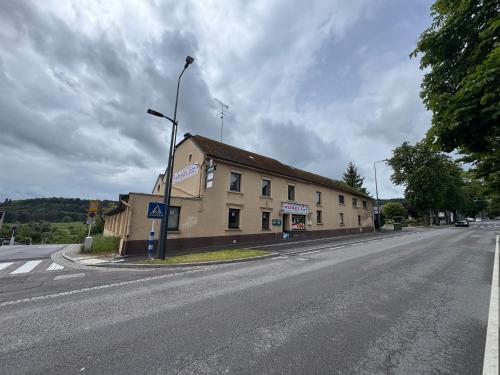 an empty street with a building on the side of a road at Himalaya Budget Inn in Niederanven