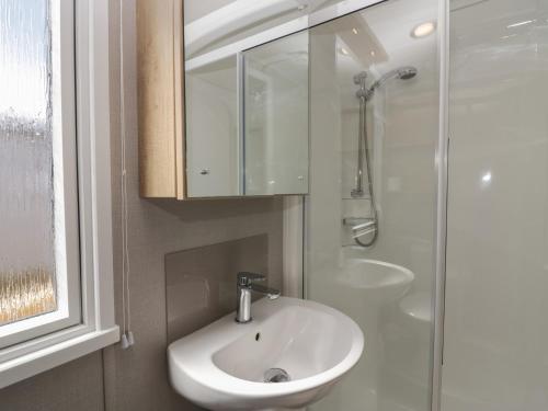a bathroom with a sink and a shower at The Swift in St Bees