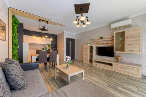 a living room with a couch and a table at Infinity View 3 Shkorpilovci in Shkorpilovtsi
