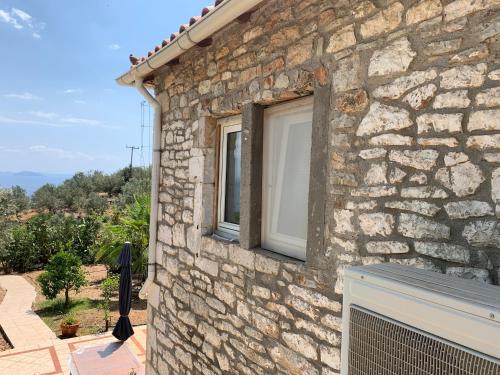 a window on the side of a stone building at The Grimme Residence in Xiropigado