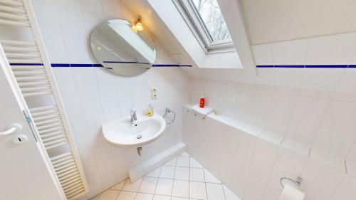 a bathroom with a sink and a mirror at Landhaus Gerdts - 1 in Cuxhaven