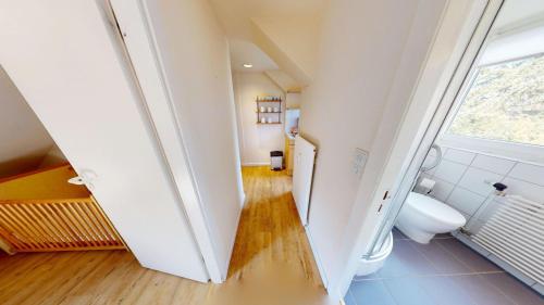 an attic bathroom with a toilet and a window at Landhaus Gerdts - 4 in Cuxhaven