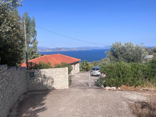 a driveway with a gate in front of a house at The Grimme Residence in Xiropigado