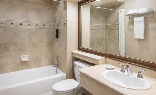 a bathroom with a sink and a toilet and a bath tub at Indian Wells Resort Hotel in Indian Wells