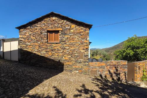 a stone building with a window on the side of it at Casa da Figueira - Rio Paiva in Arouca