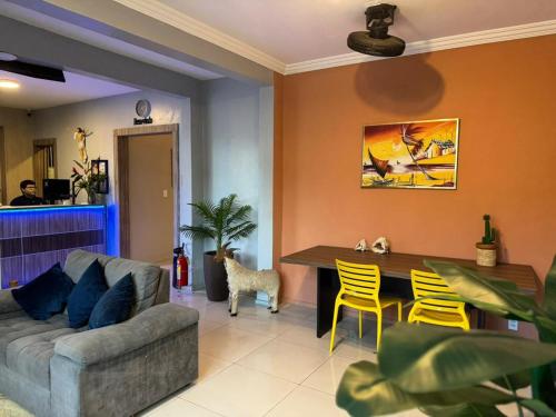 a living room with a couch and a table at Hotel Aeroporto Star in Fortaleza