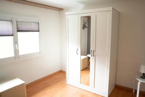 a white door in a room with a window at Ufer Nest in Buochs in Buochs