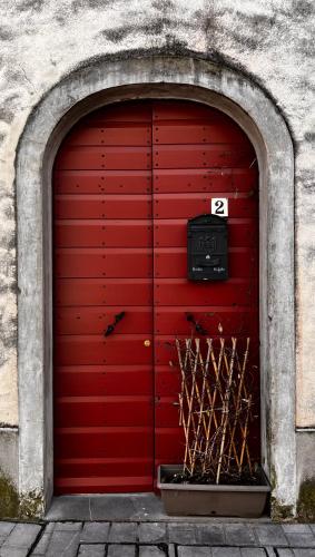 a red garage door with the number twentytwo at Casa Stella in Venzone