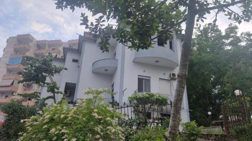 a white building with two balconies on the side of it at Guest House Kocollari in Gjirokastër