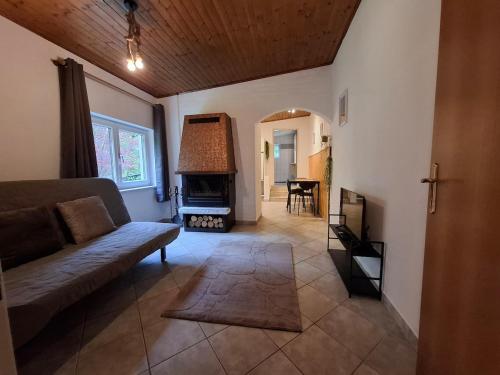 a living room with a couch and a fireplace at Cozy Cottage in Nature in Bernstein