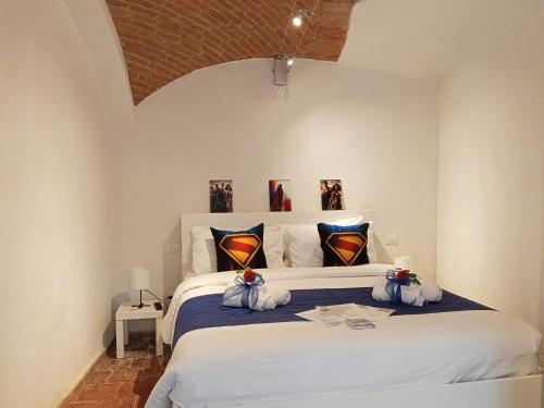 a bedroom with a large white bed with pillows at G&G Giusy e Gabry in Viverone