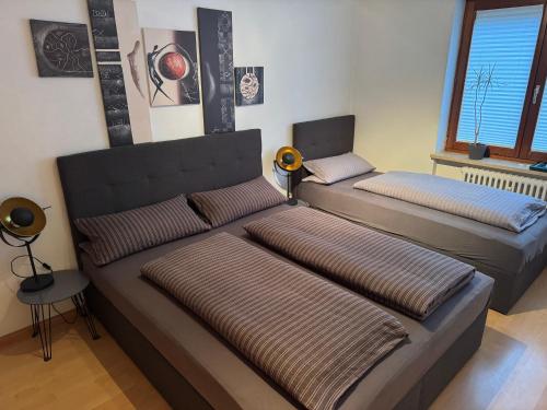 two beds in a living room with a couch at Ferienwohnung Novotny in Lörrach