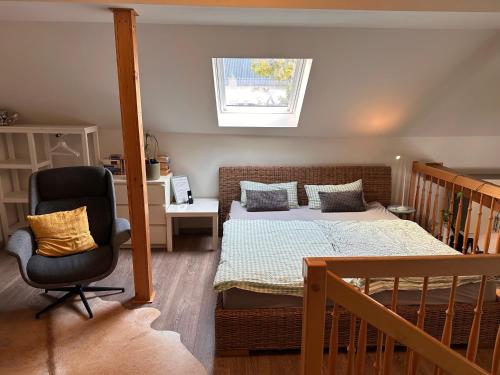 a bedroom with a bed and a desk and a chair at Ferienwohnung Westerburg in Westerburg