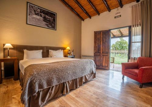 a bedroom with a bed and a chair and a window at Postales by DOT Boutique in Colonia Las Rosas