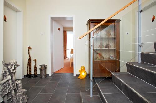 a hallway with black tile flooring and stairs at Pension Klug Adults only - DorfResort Mitterbach in Mitterbach