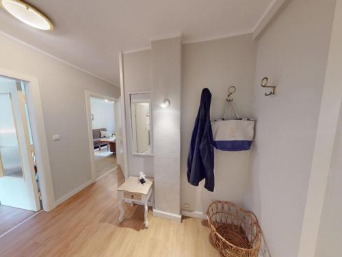 a room with a hallway with a table and a mirror at Landhaus Gerdts - 5 in Cuxhaven