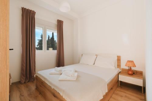 a bedroom with a bed with two towels on it at Apartments BUBBLES with pool in Gevgelija
