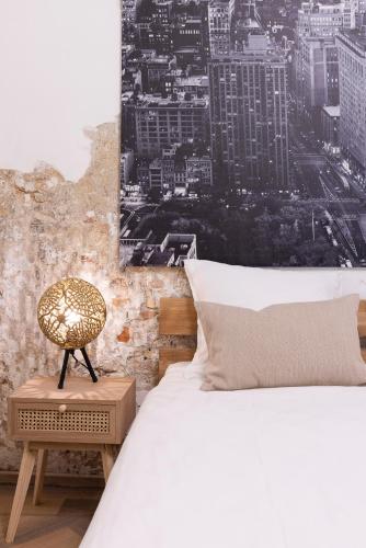 a bedroom with a white bed and a chair at Oak & Beam Atelier in Haarlem
