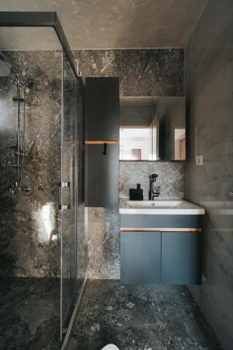a bathroom with a sink and a shower at Apartments BUBBLES with pool in Gevgelija