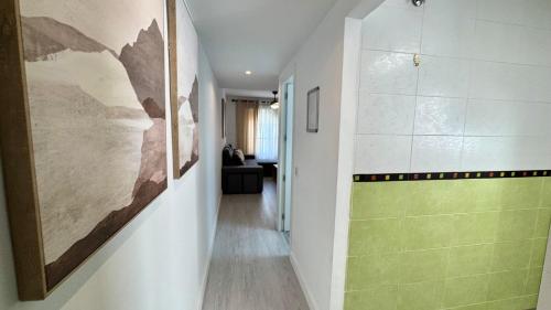 a hallway with a green accent wall in a house at San Miguel Centro in Torremolinos