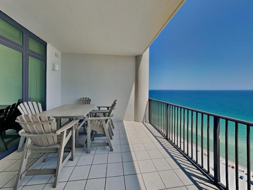 a balcony with a table and chairs and the ocean at The Oasis Orange Beach 2110 in Orange Beach