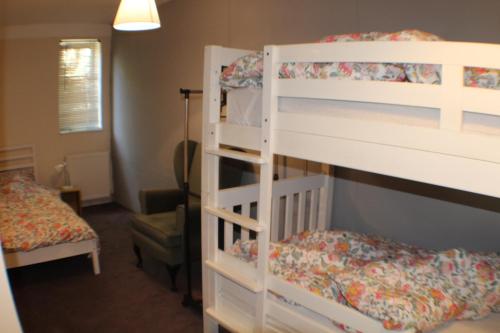 a bedroom with two bunk beds and a bed at Grove Stables in Kirk Leavington