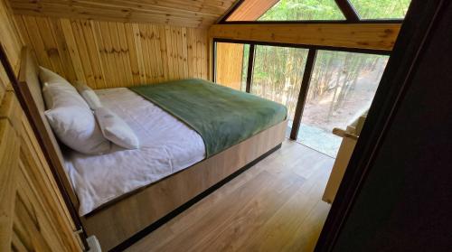 a bed in a small room with a window at Secret Sanctuary in Brad