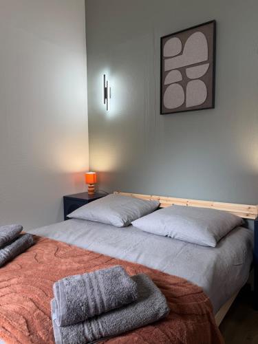 a bedroom with two beds with towels on it at Duplex T2 cosy - Hyper Centre - Parking privé in Bourges