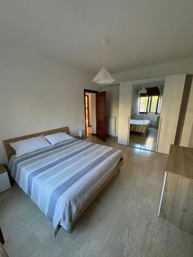 a bedroom with a large bed and a living room at Home Marí in Sessa Aurunca