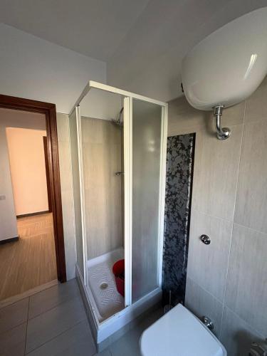 a bathroom with a shower with a toilet and a sink at Home Marí in Sessa Aurunca