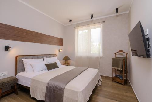 a bedroom with a large bed and a television at Mare Vista Rooftop Penthouse Sea View & Private Jacuzzi in Trogir