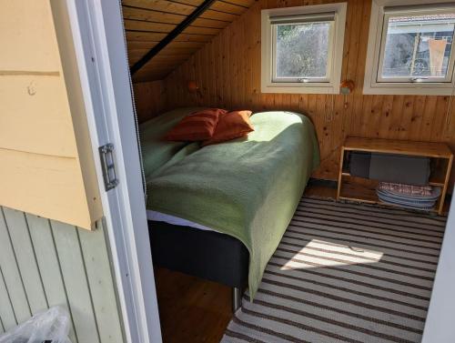 a bed in a small room in a house at Marielyst Summer House in Bøtø By