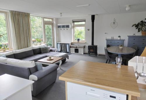 a living room with a couch and a table at VolopVeluwe in Ermelo