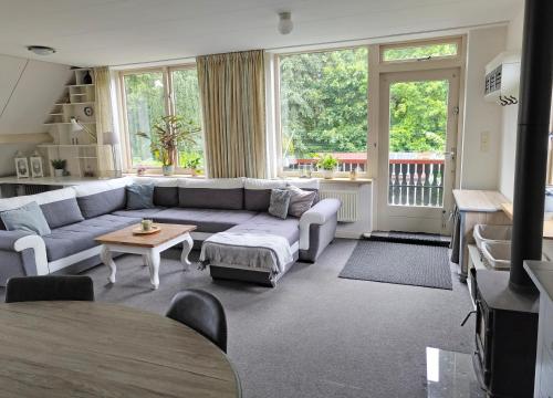 a living room with a couch and a table at VolopVeluwe in Ermelo