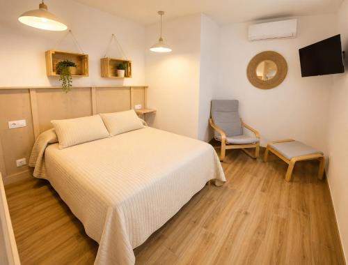 a bedroom with a bed and a chair in it at DUNA - Escapada romántica en Punta Paloma in Tarifa