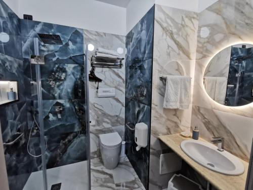 a bathroom with a sink and a toilet at Il Giardino del Sol in San Vito lo Capo