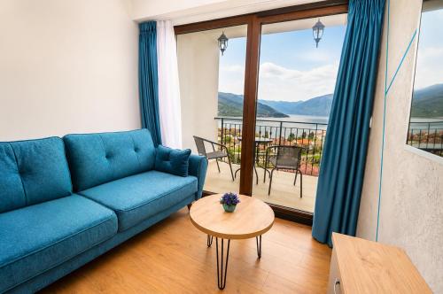 a living room with a blue couch and a table at Apartments NOCE - Premium Lake View in Ohrid