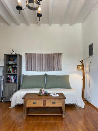 a living room with a bed and a table at Vorino house in Amorgos