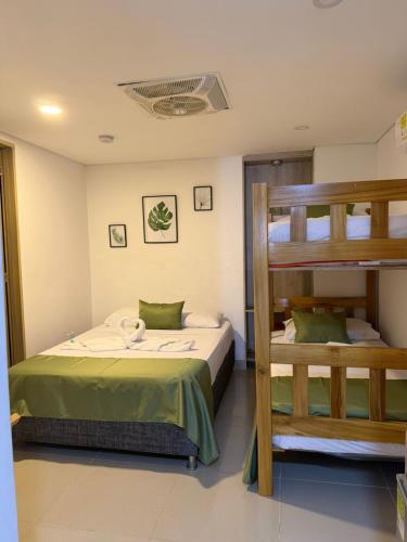 a bedroom with a bunk bed and a ladder at Hotel Carolina Del Mar in Santa Marta