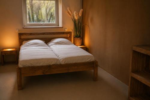 a bed in a room with a window at Appartement voor Gezin Ardennen The Moon Valley in Amblève