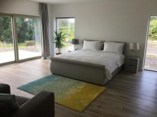 a bedroom with a bed and a large window at Skyelyne in Ardvasar
