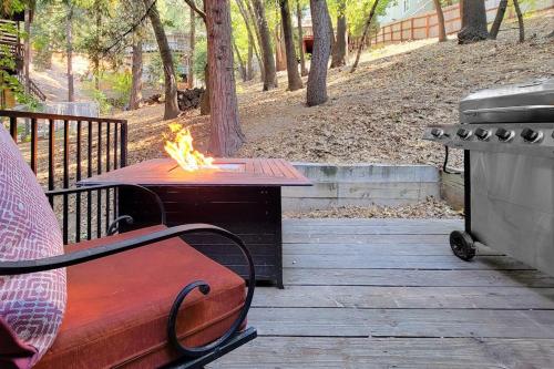 a fire pit with a bench and a grill at Lake Gregory Escape in Crestline