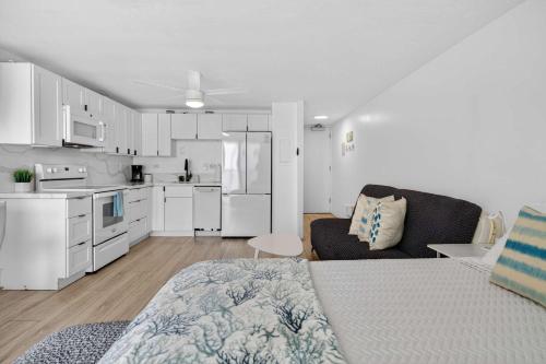 a living room with a bed and a kitchen at Luxury Beachfront Condo in Hauula