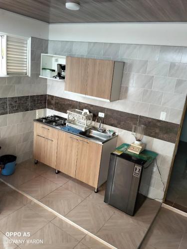 a kitchen with a sink and a stove top oven at Apartamento independiente, fresco y cómodo in Acacías
