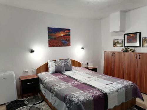 a bedroom with a bed with a quilt on it at Casa de vacanta Amira in Sfântu Gheorghe