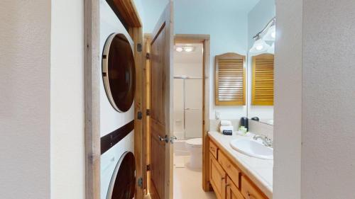 a bathroom with a sink and a toilet and a mirror at Ridge Condo 2610 in Sun Valley