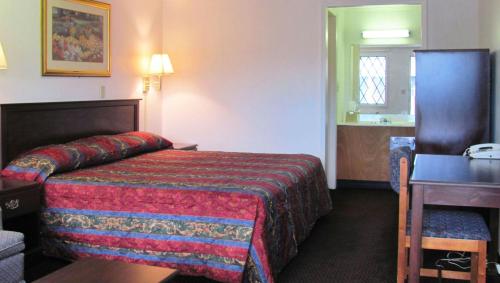 a hotel room with a bed and a desk at M Star Columbus North in Worthington