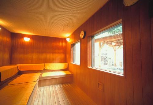 a bench in a room with a window at Hakonenomori Okada in Hakone